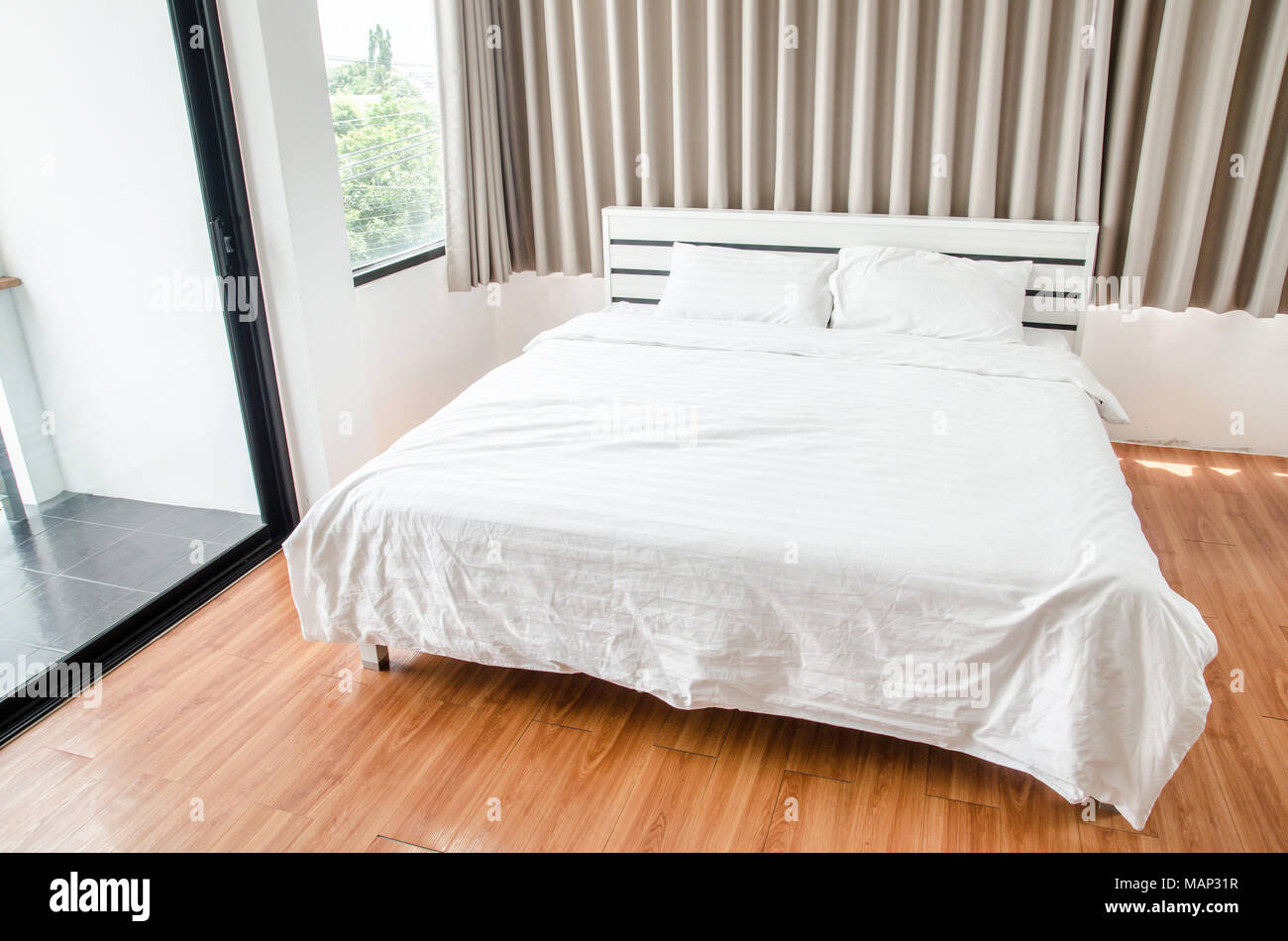 quilt bed white pillows on white bed in bedroom Stock Photo Alamy