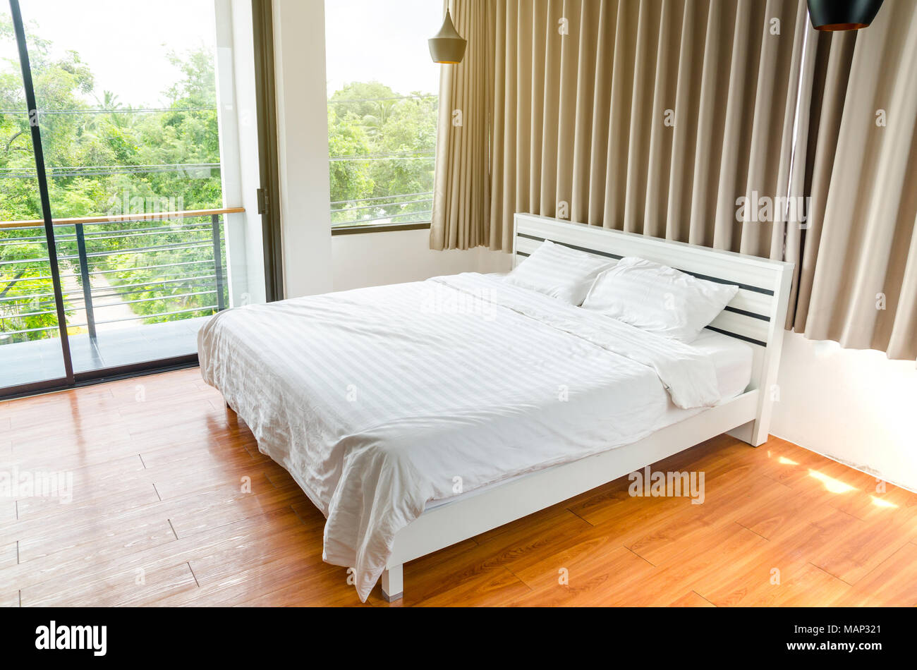 quilt bed white pillows on white bed in bedroom Stock Photo Alamy