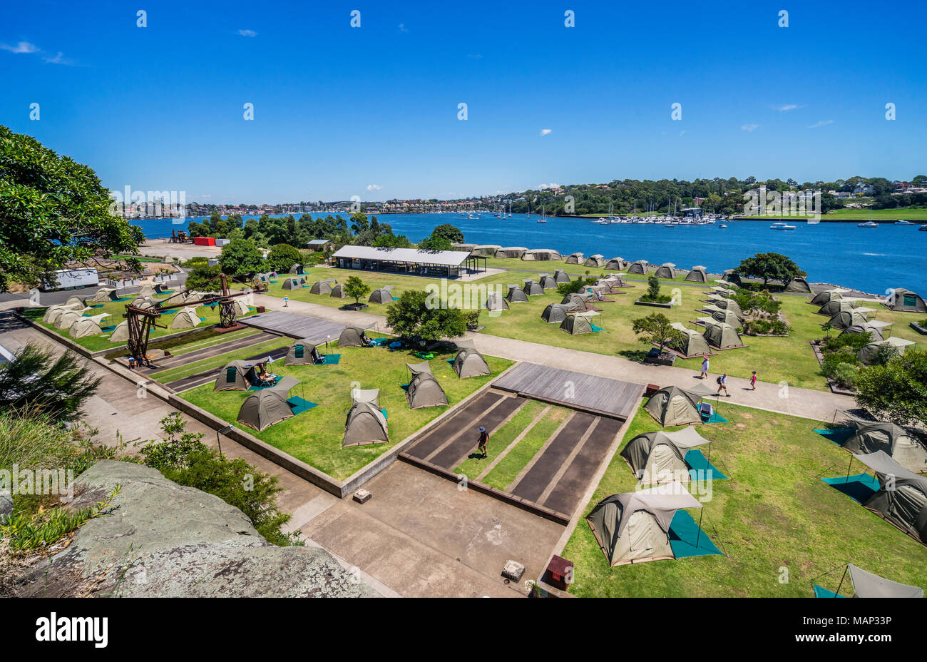 tent city campground for overnight visitors to Cockatoo Island shipyard heritage site, Sydney Harbour, New South Wales, Australia Stock Photo