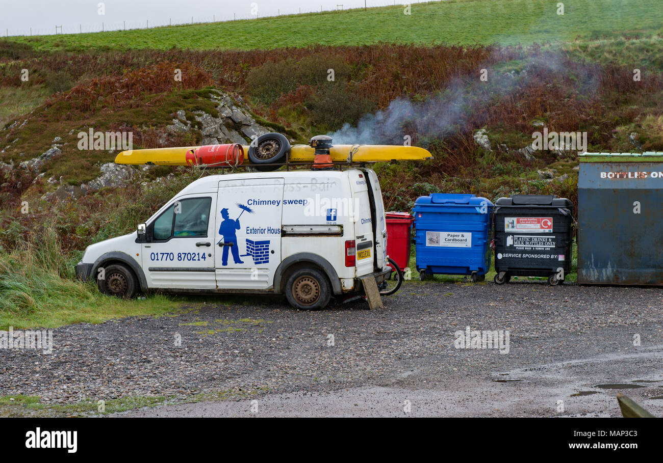 Chimney Sweeps van that appears to be being used to live in.  Note smoking chimney on roof.  Cloanaig, Kintyre Scotland UK Stock Photo