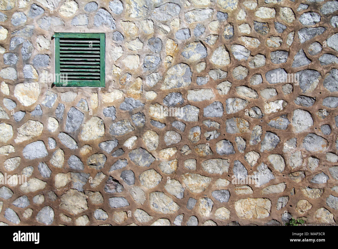 Green Painted Wooden Shutter on a traditional Granite Stone Wall Stock ...