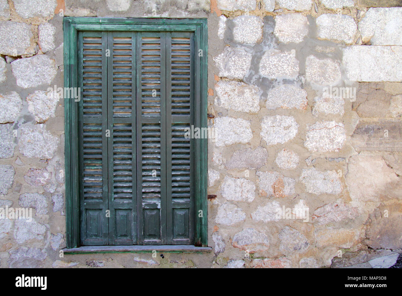 Green Painted Wooden Shutter on a traditional Granite Stone Wall Stock ...