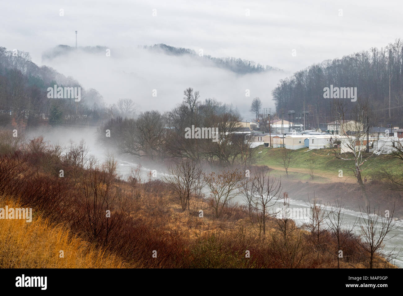 Mist rises in the background of this rural residential scene. Stock Photo