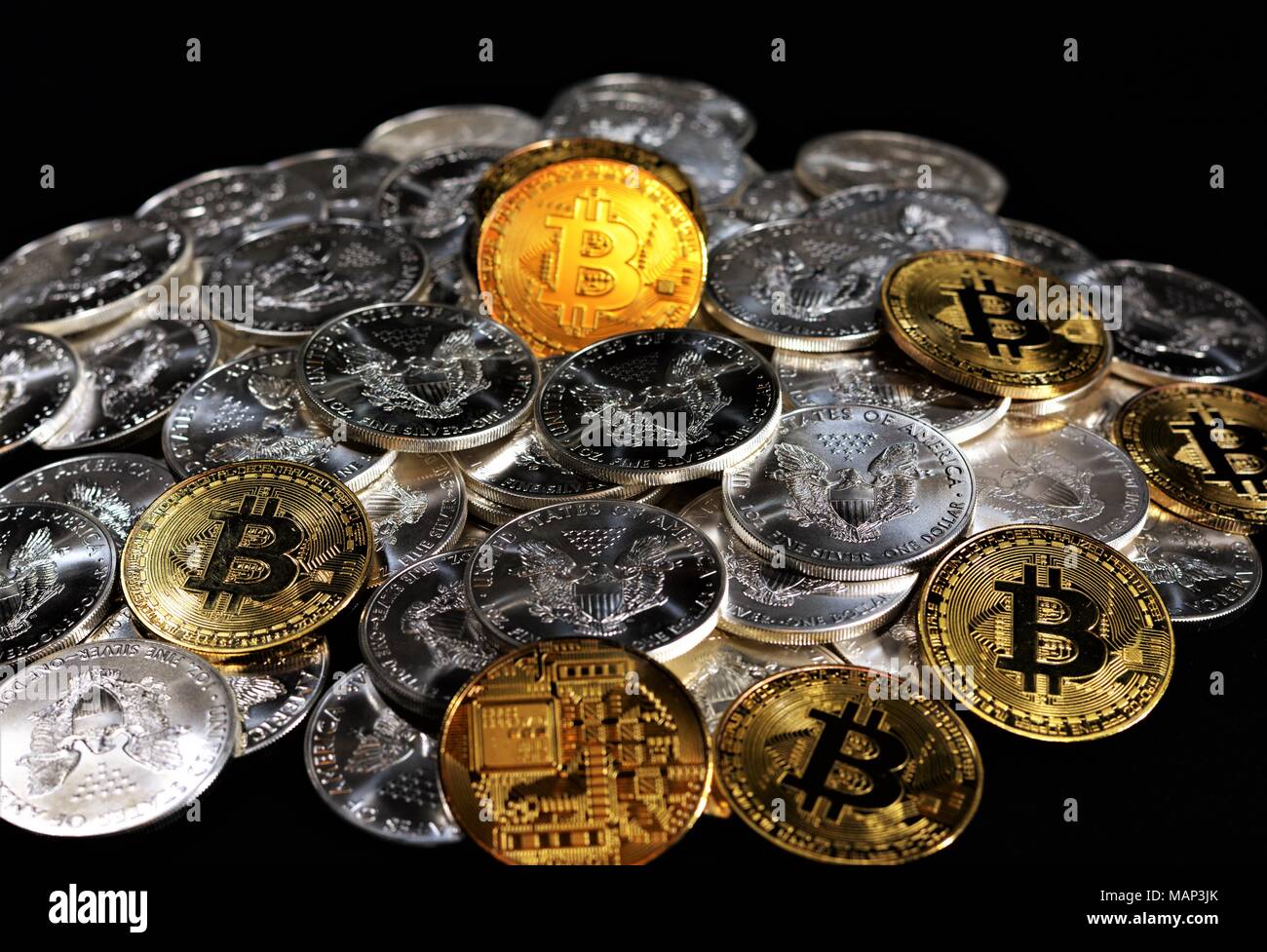 Bit coins with silver dollars and diamonds Stock Photo - Alamy