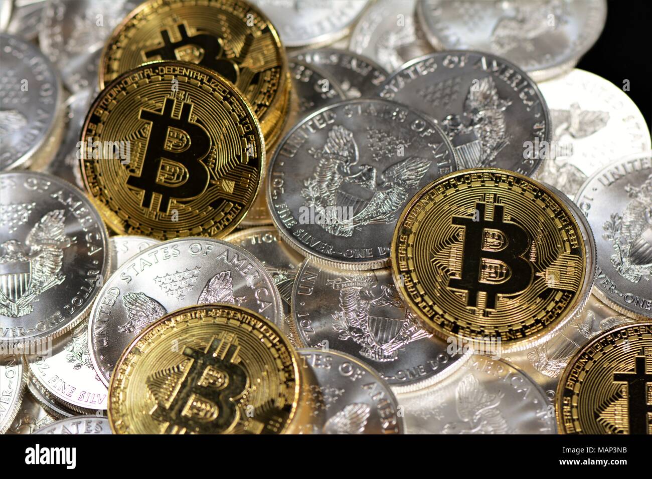 Bit coins with silver dollars and diamonds. Stock Photo