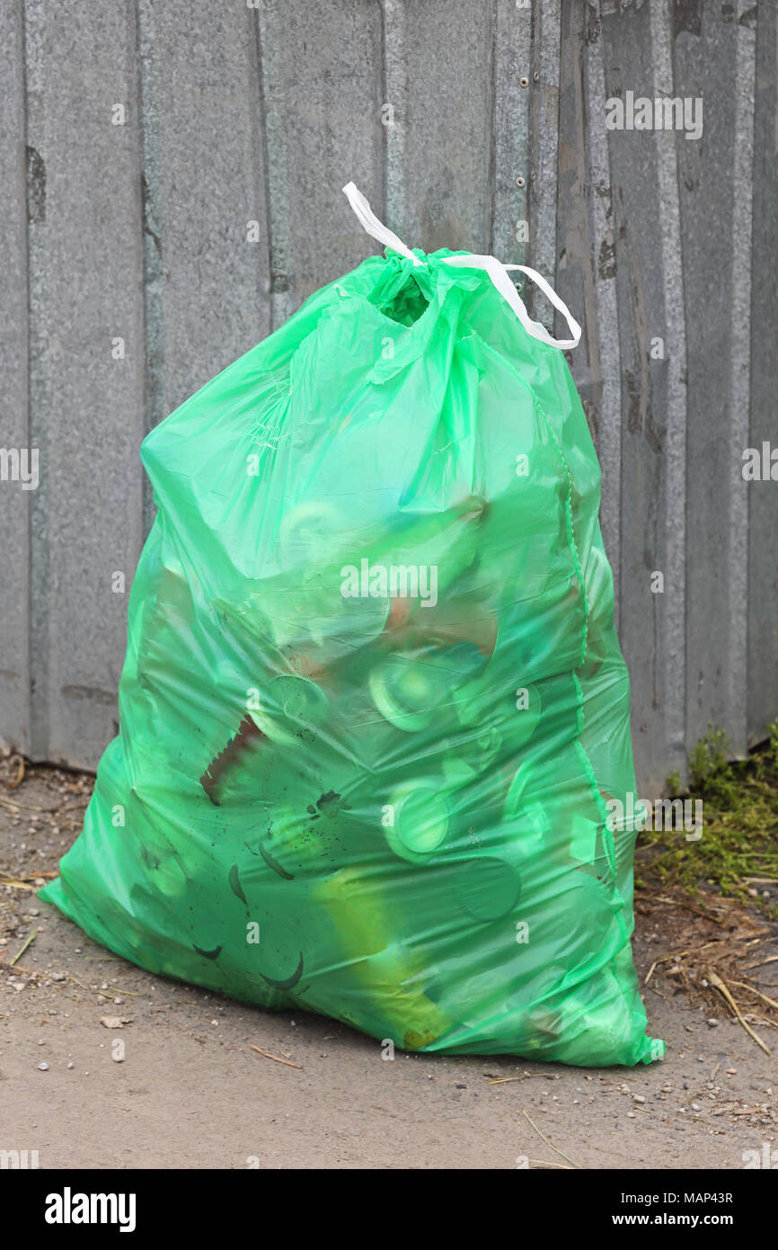 Green Bin Bag With Garbage at Street Stock Photo