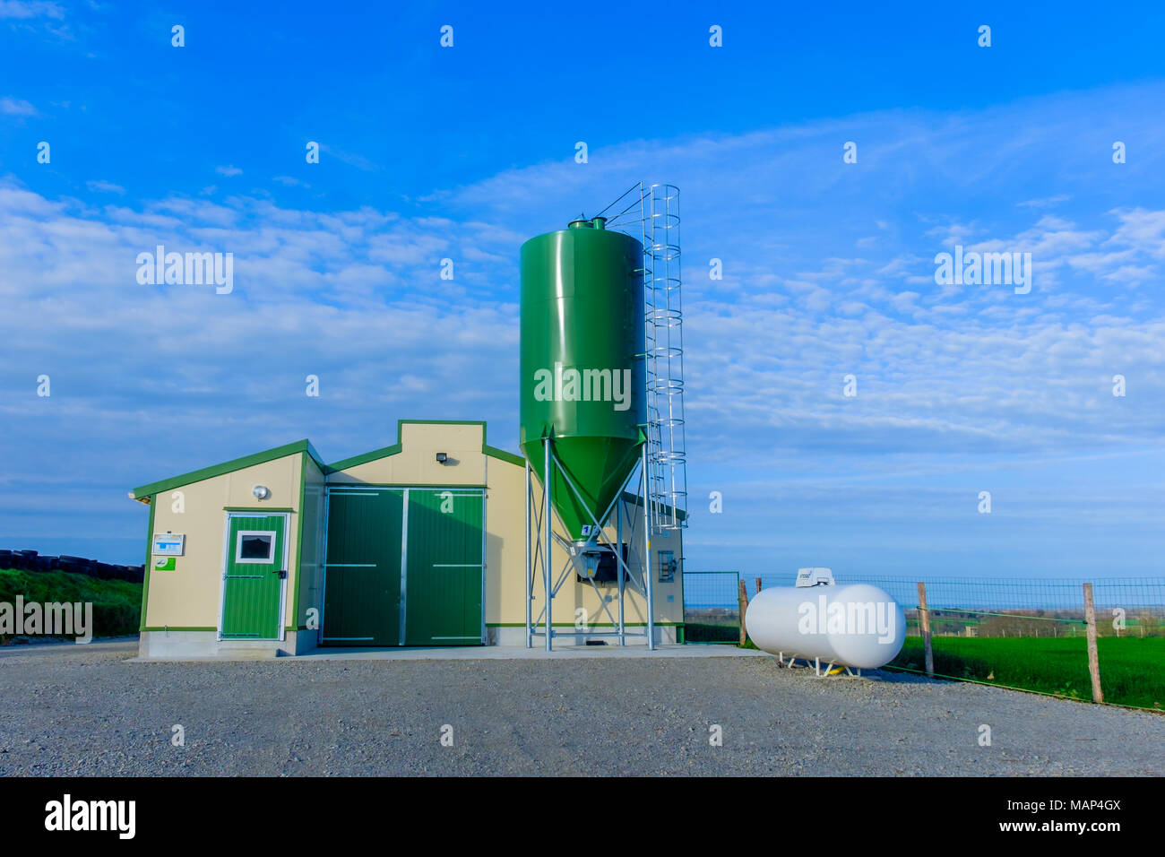 Mayenne, France, March 2017, chicken farm with a feed silo tank in the French countryside Stock Photo