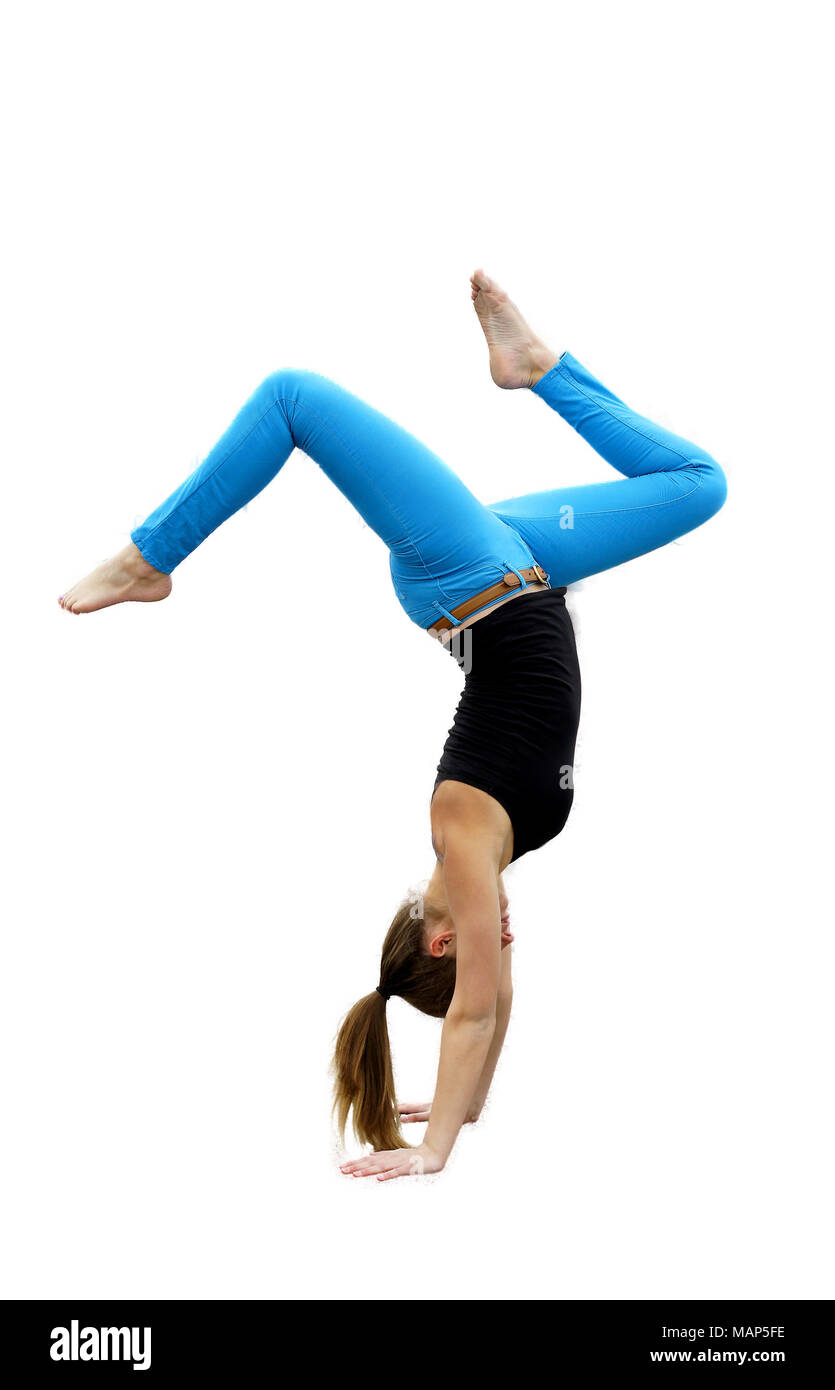 Gymnast doing hand stand isolated on white background. Royal blue pants and black shirt, pony tail swishing ground with legs bent. Stock Photo