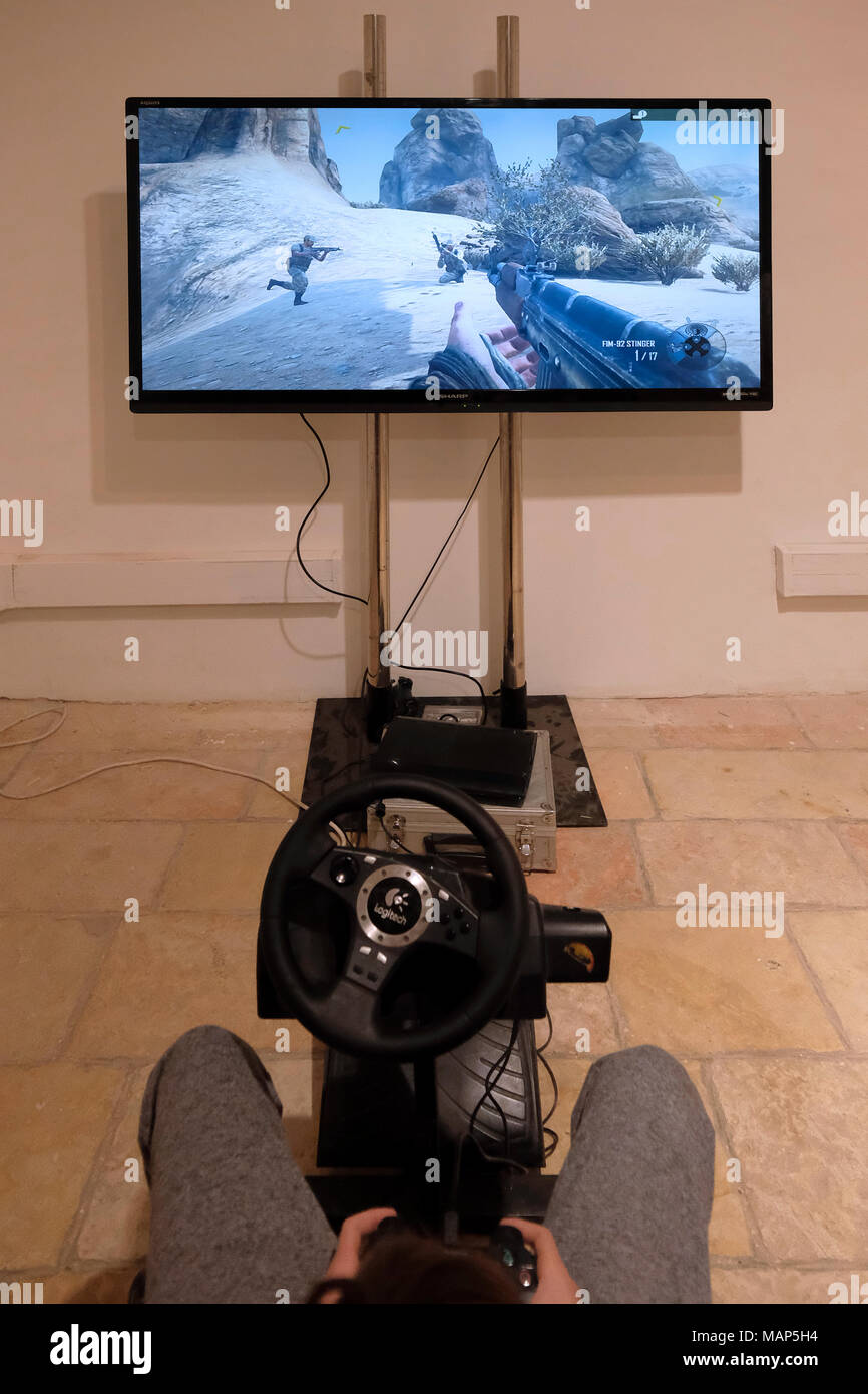 a young boy playing violent simulated war video game with a PlayStation 3 ( PS3) console Stock Photo - Alamy