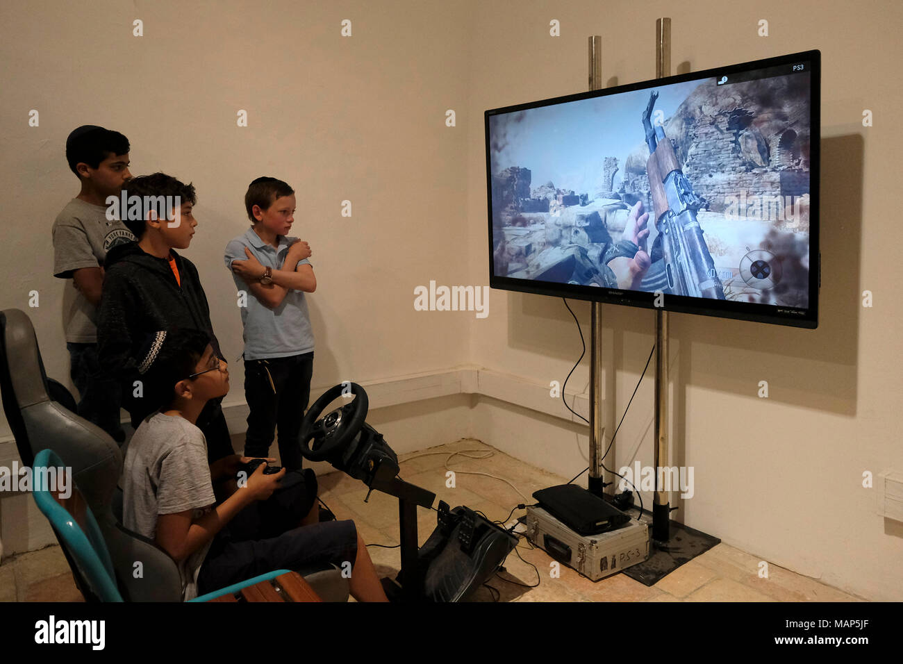 Israeli children playing violent simulated war video game with a  PlayStation 3 (PS3) console in Jerusalem Israel Stock Photo - Alamy