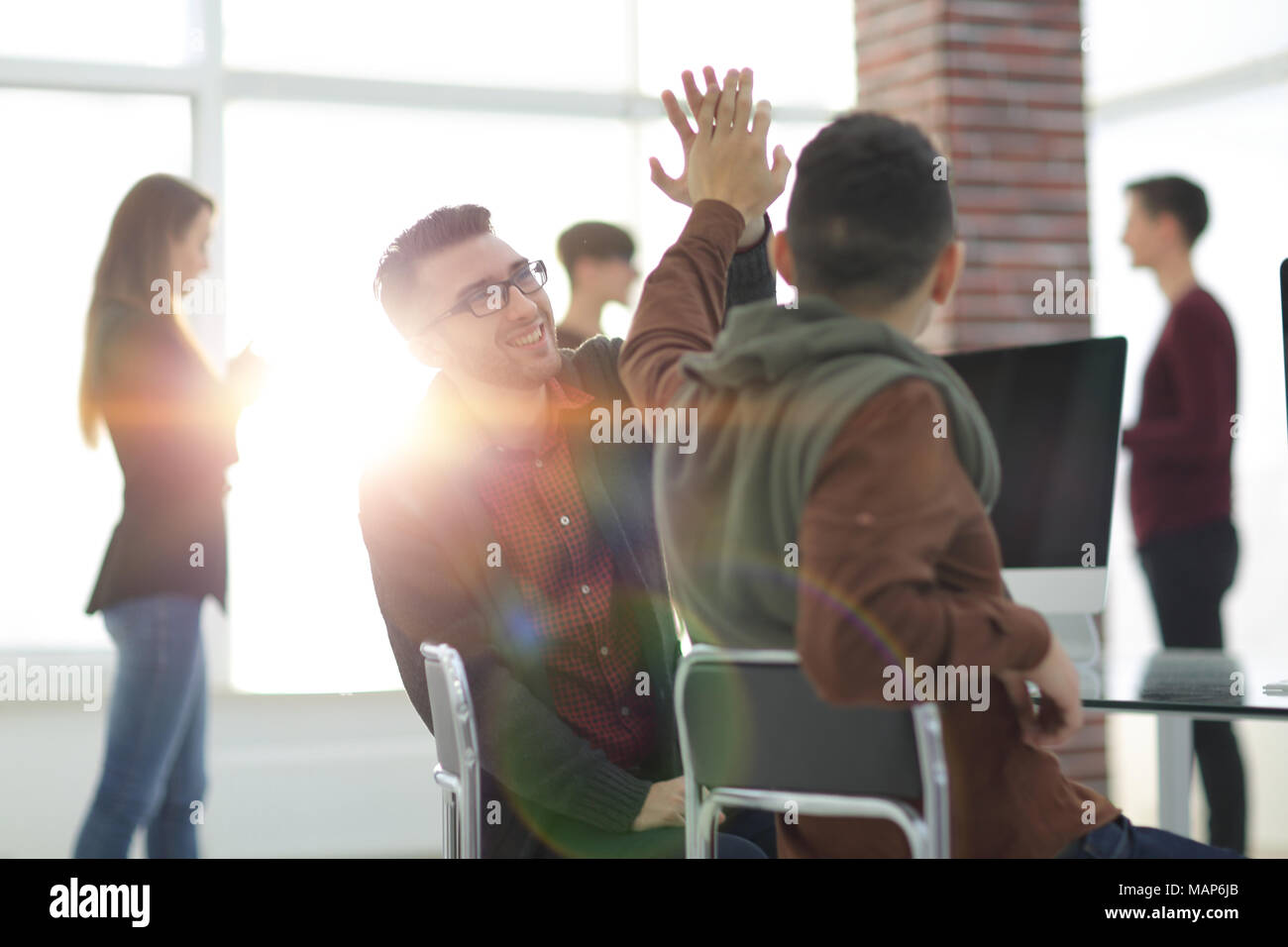 business colleagues giving each other high five Stock Photo - Alamy