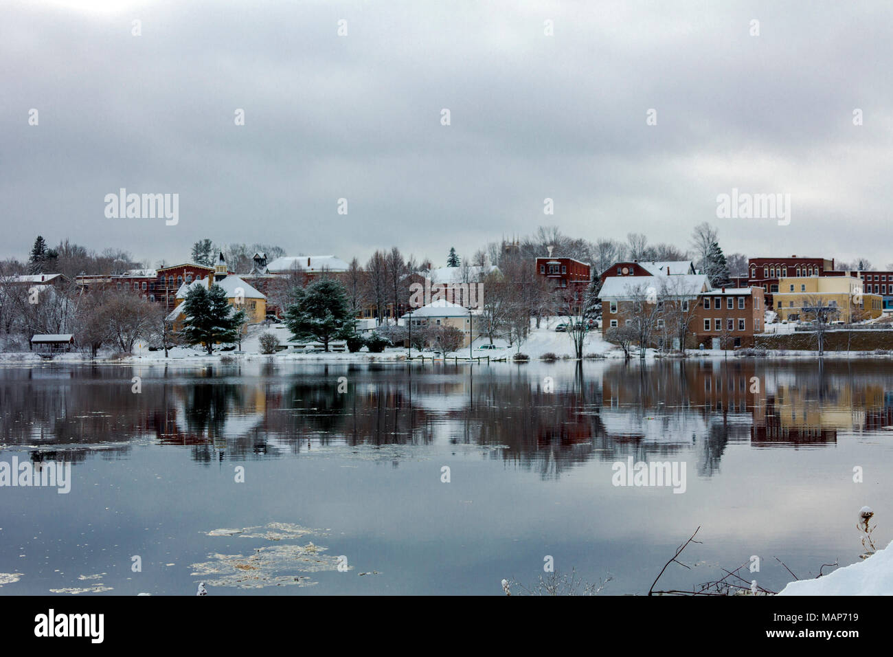 View of Calais, Maine across the US/Canada border from St. Stephen, New Brunswick, in winter with snow and cloudy skies Stock Photo