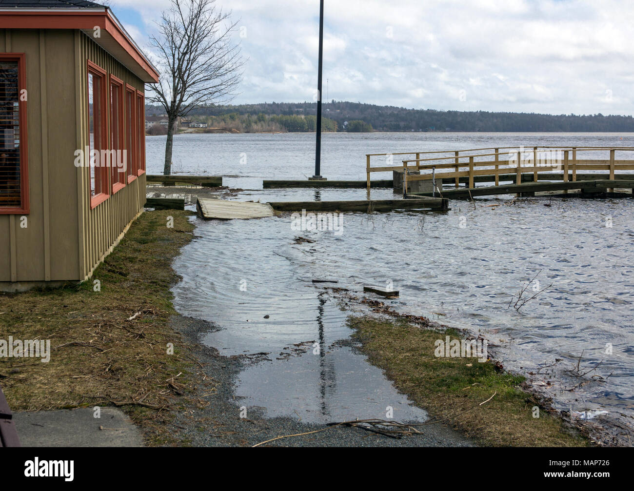 Flooding at king tide on the St. Croix river in St. Stephen, New Brunswick, Canada, with water almost reaching Pizza Delight building Stock Photo