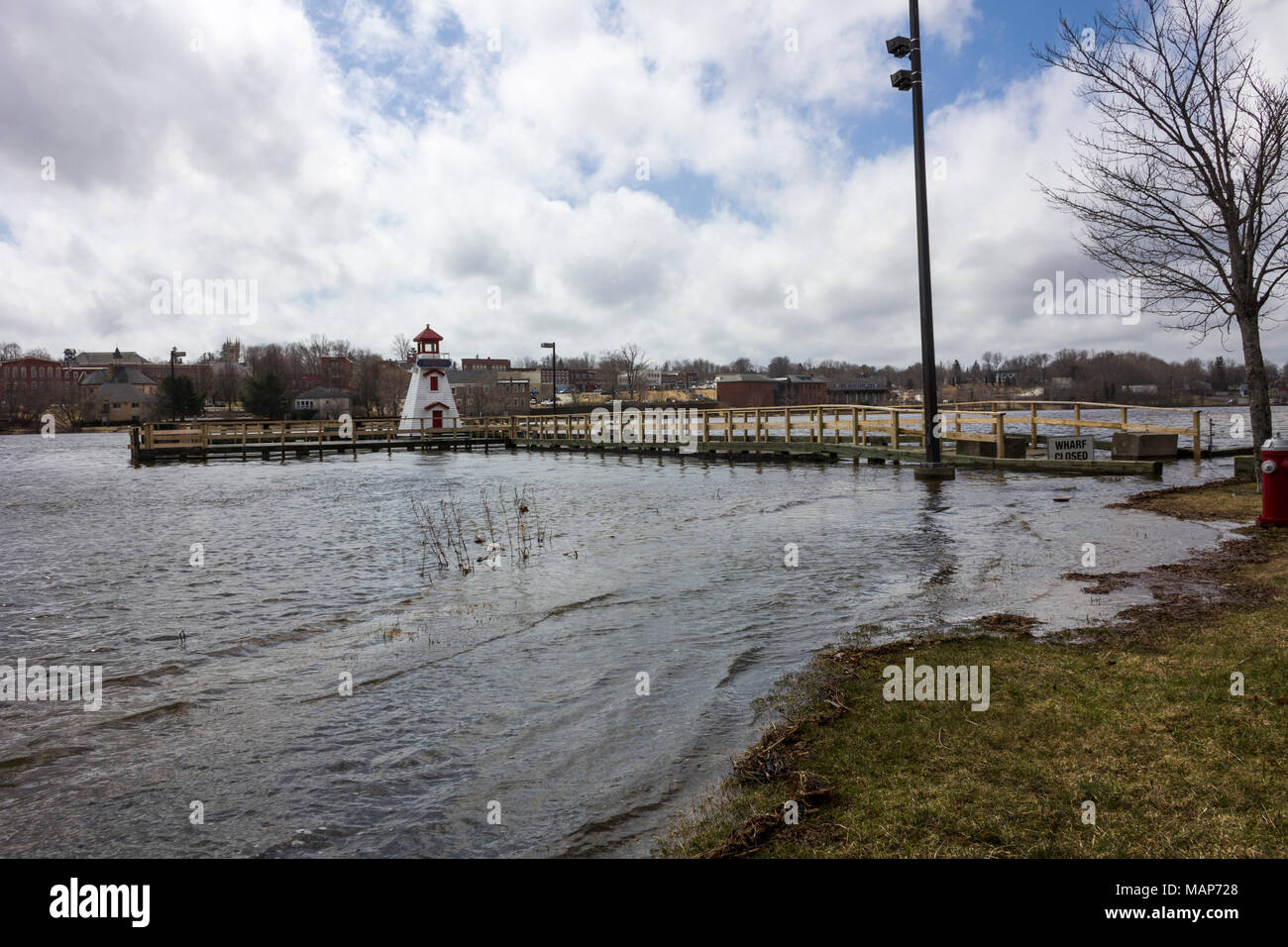 Flooding at king tide on the St. Croix river in St. Stephen, New Brunswick, Canada with water covering the riverside walkway Stock Photo