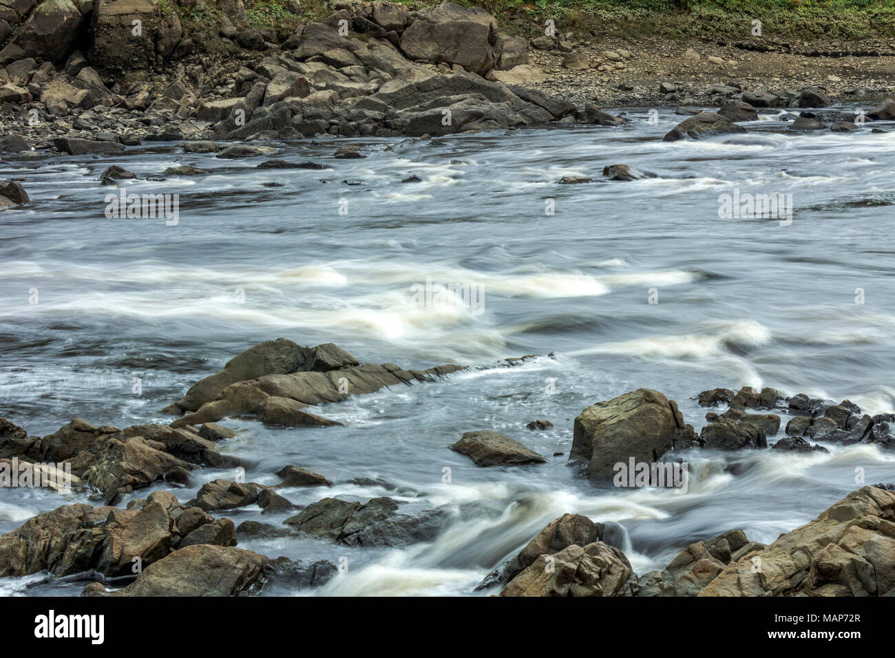 Rapids on the St. Croix river at low tide between downtown St. Stephen