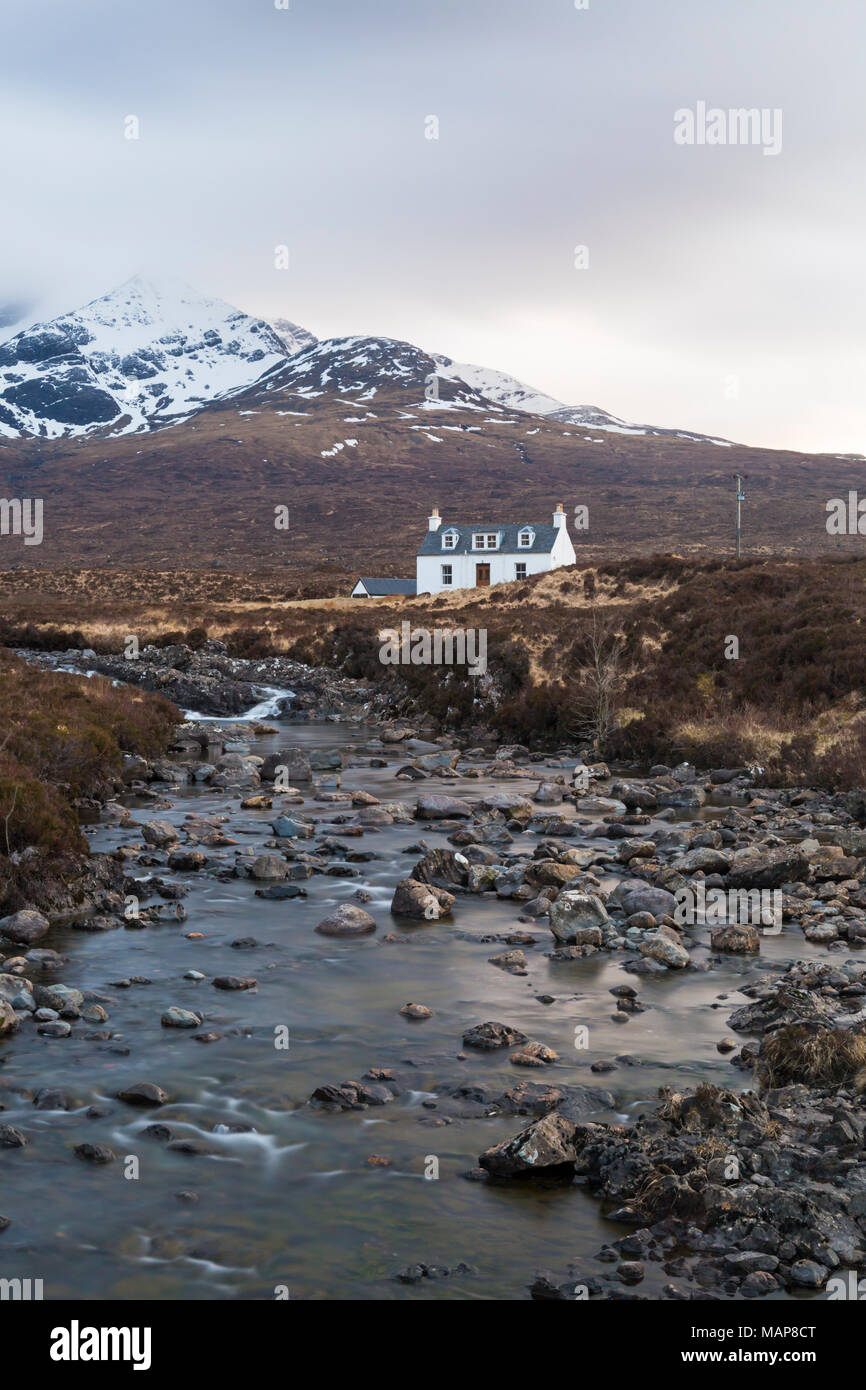 Allt Dearg holiday cottage near Sligachan with Sgurr Nan Gillean, Cuillin mountain, Isle of Skye, Scotland, UK in March - long exposure Stock Photo