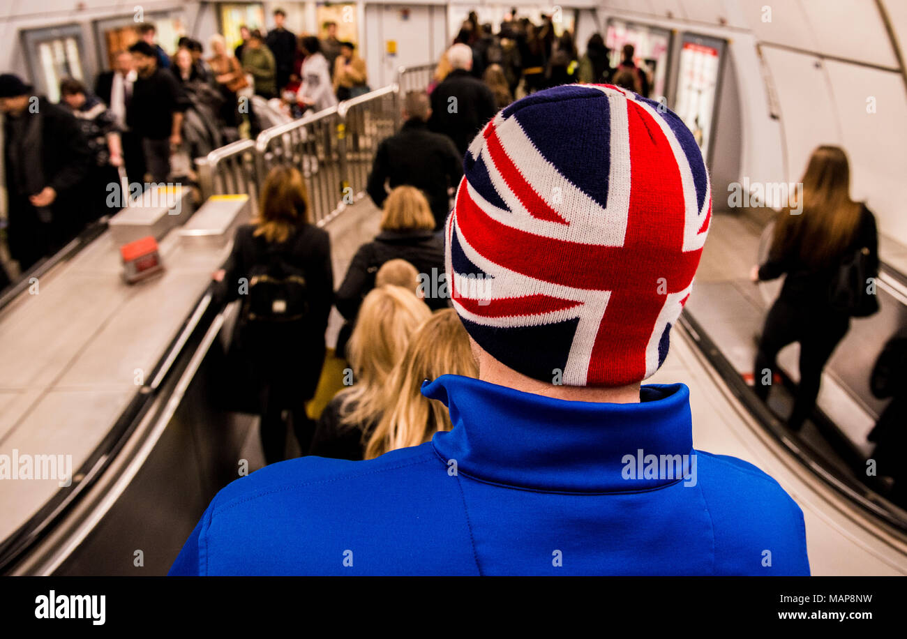 Man wearing Union Jack hat on London Underground, London, England, UK Stock Photo