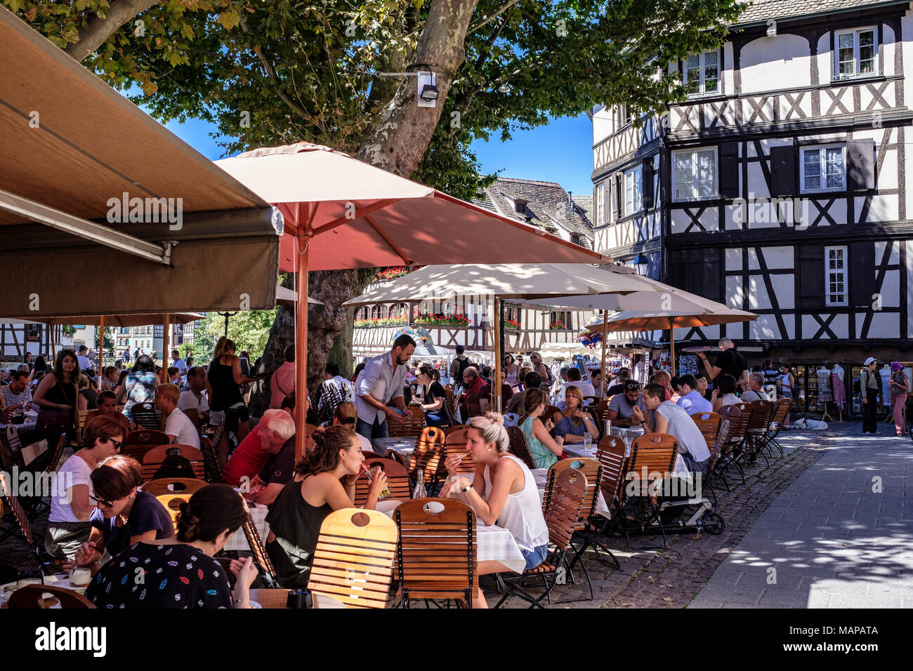 Alfresco cafe terrace, customers lunching, half-timbered houses, place Benjamin Zix square, La Petite France, Strasbourg, Alsace, France, Europe, Stock Photo