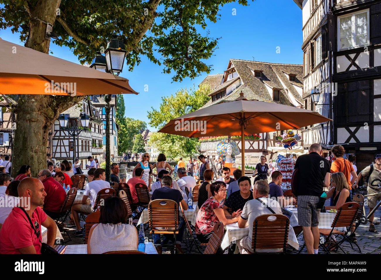 Alfresco cafe terrace, customers lunching, half-timbered houses, place Benjamin Zix square, La Petite France, Strasbourg, Alsace, France, Europe Stock Photo
