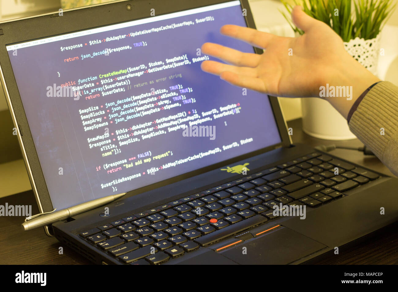 Web developer pointing to PHP code on the screen. Digital technology modern background. Stock Photo