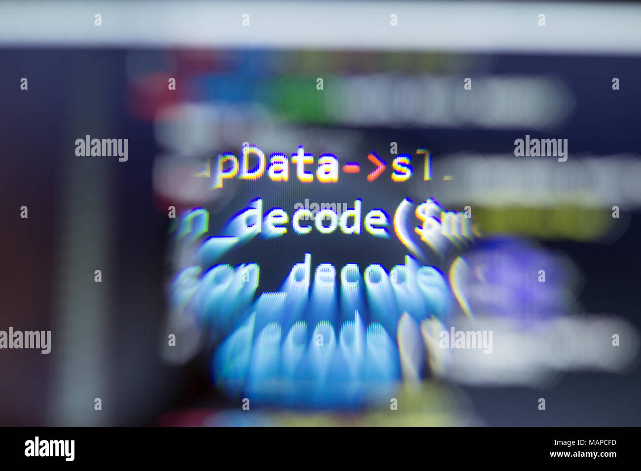 PHP back-end code zoomed through a magnifier. Computer programming source code lookup. Abstract screen of web developer. Stock Photo
