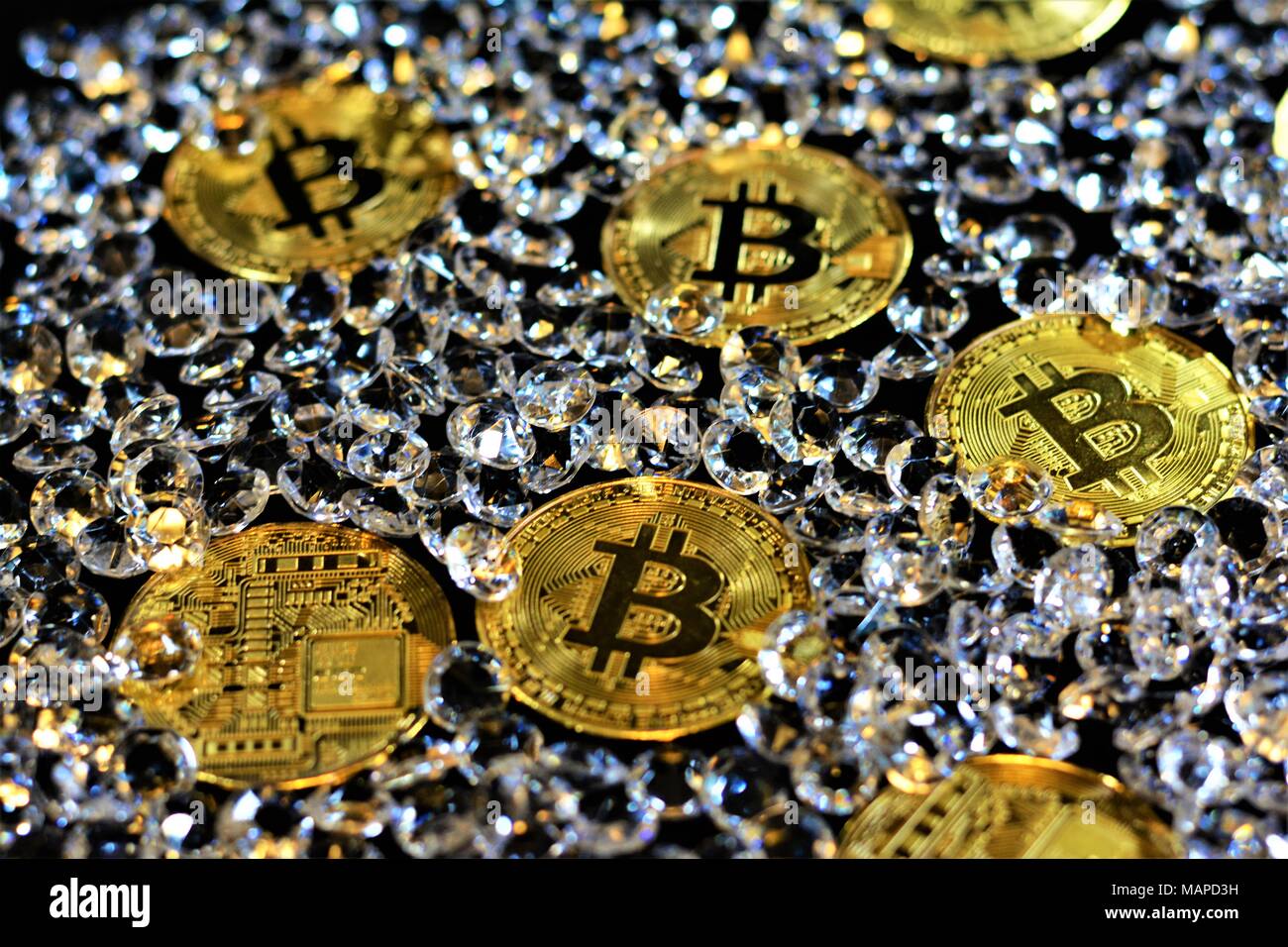 Bit coins with silver dollars and diamonds. Stock Photo