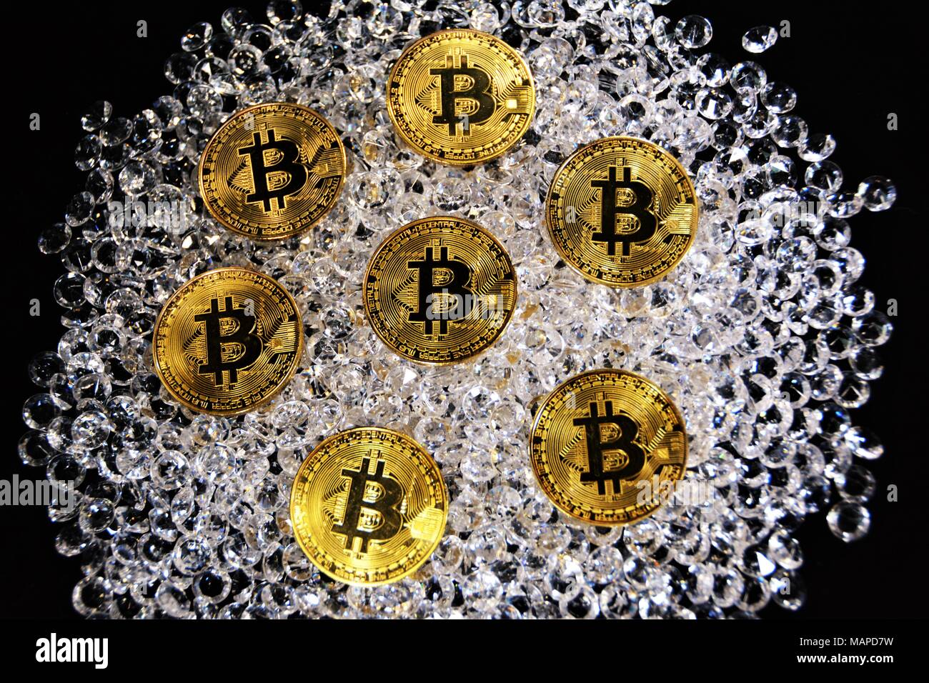 Bit coins with silver dollars and diamonds. Stock Photo
