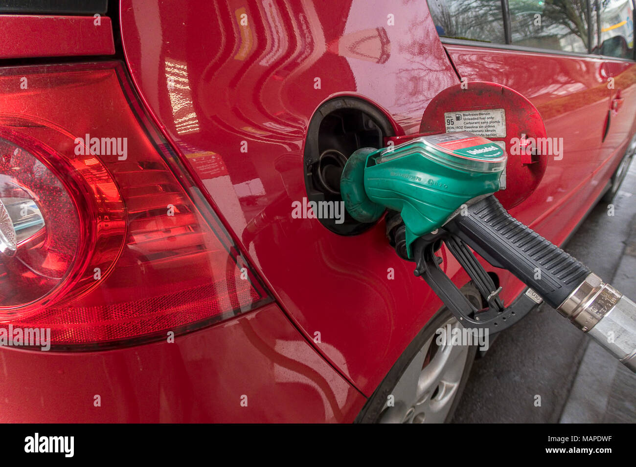 Close up image of a car being filled with fuel at a petrol station, London, England Stock Photo