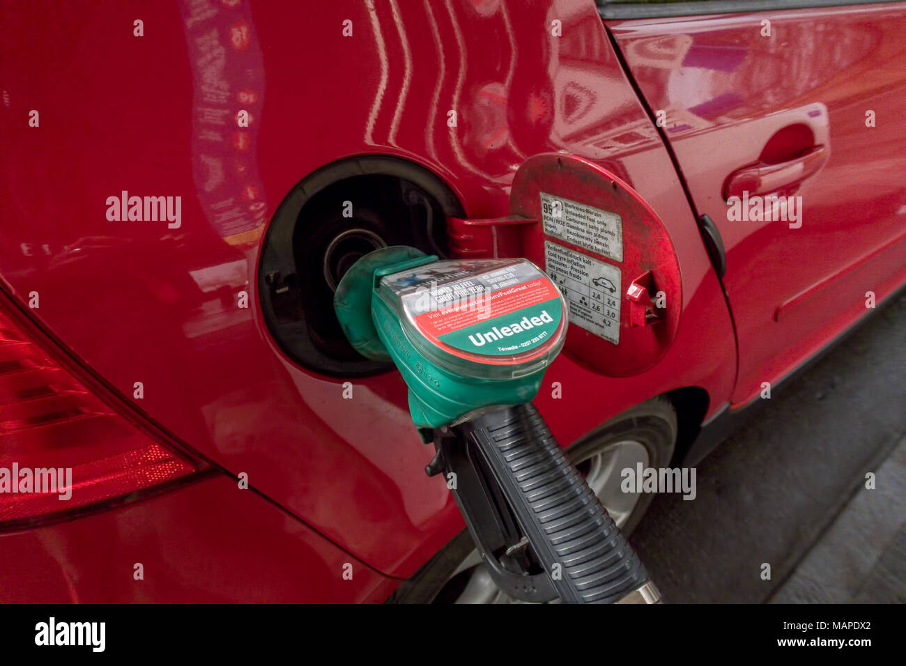 Close up image of a car being filled with fuel at a petrol station