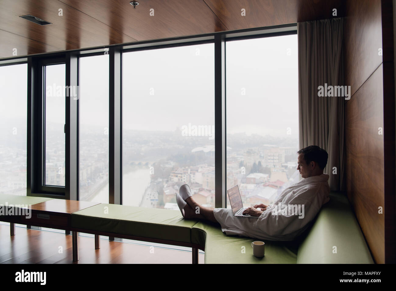 Young man freelancer working from home on a laptop Stock Photo