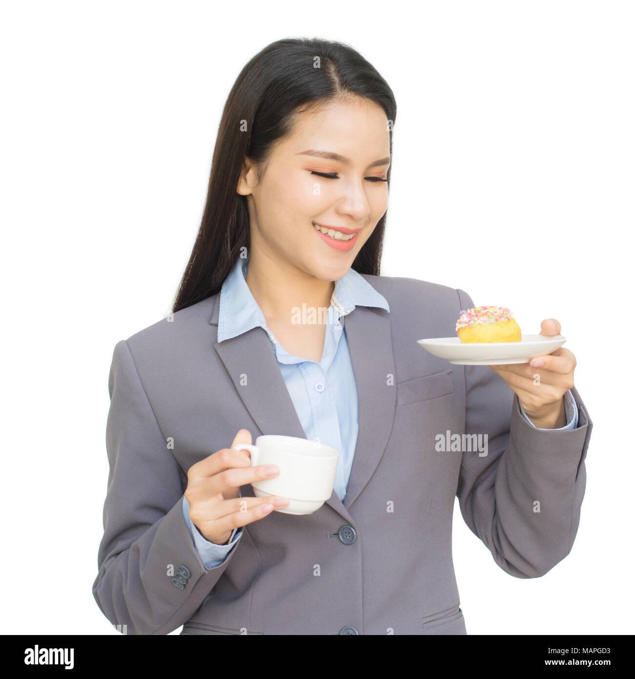 Portrait of business woman with cup of tea or coffee and one hand holding donut isolated on white background Stock Photo