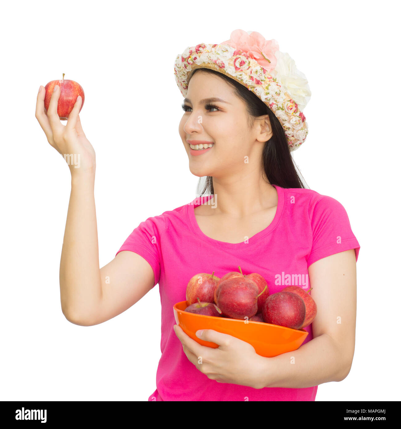 Portrait of lovely young woman holding a fresh ripe apple in bowl and smiling isolated on white background with clipping path. Healthy eating concep. Stock Photo