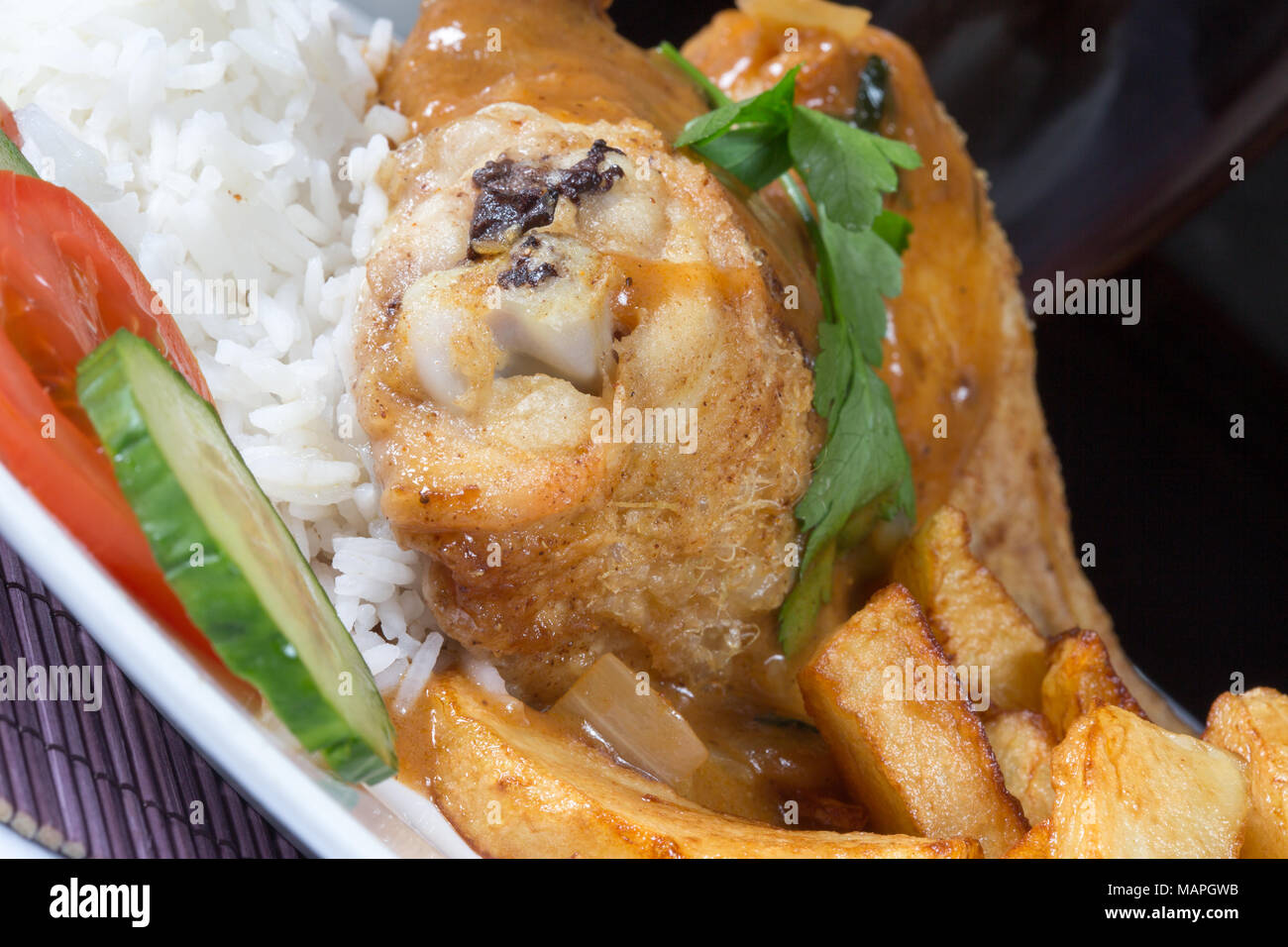 An English pub/restaurant plate of Chicken and boiled rice with chips/fries and English chip