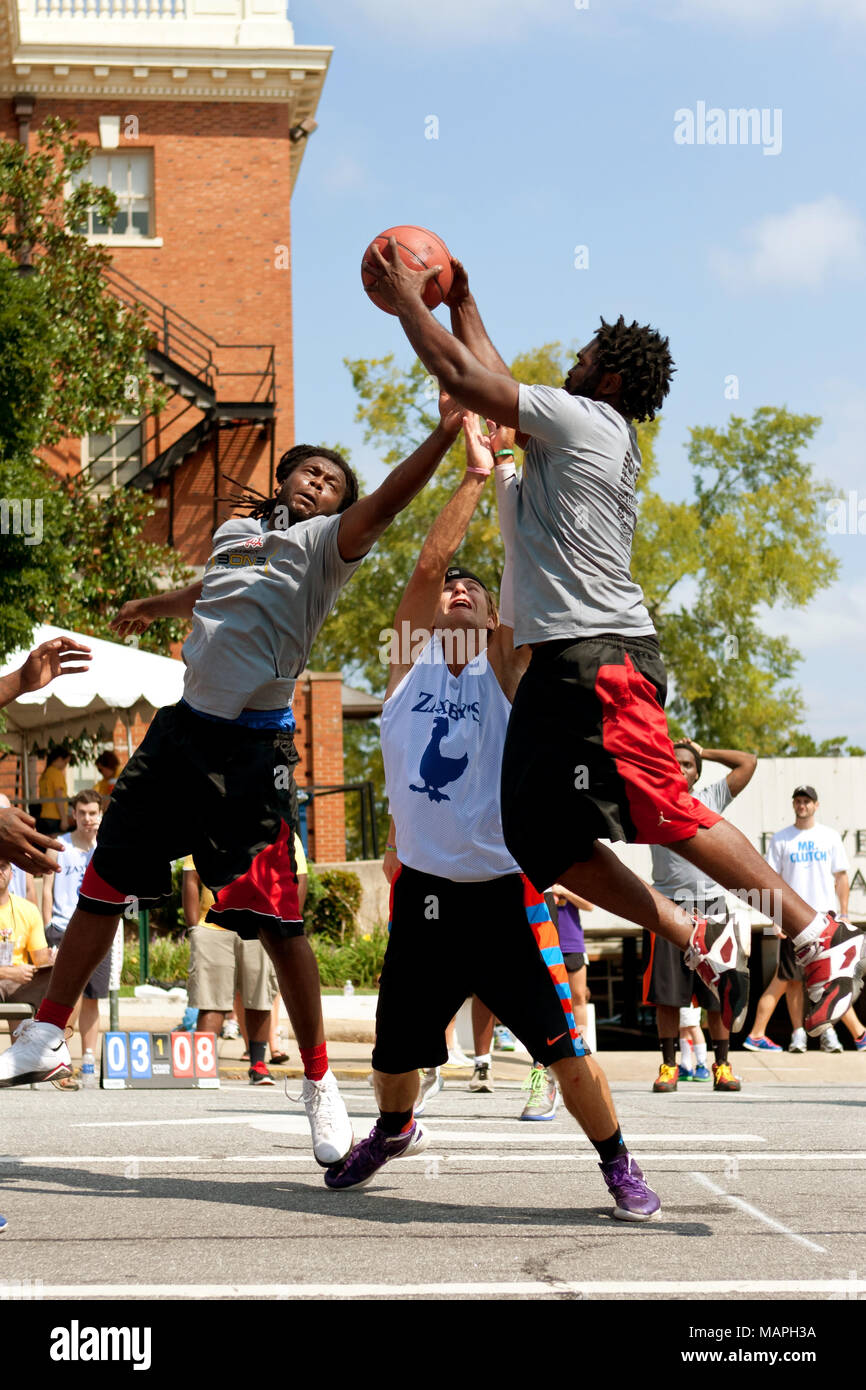 Three young men fight for a rebound while playing in a 3-on-3 basketball  tournament held on the streets of downtown Athens, GA, on August 24, 2013  Stock Photo - Alamy