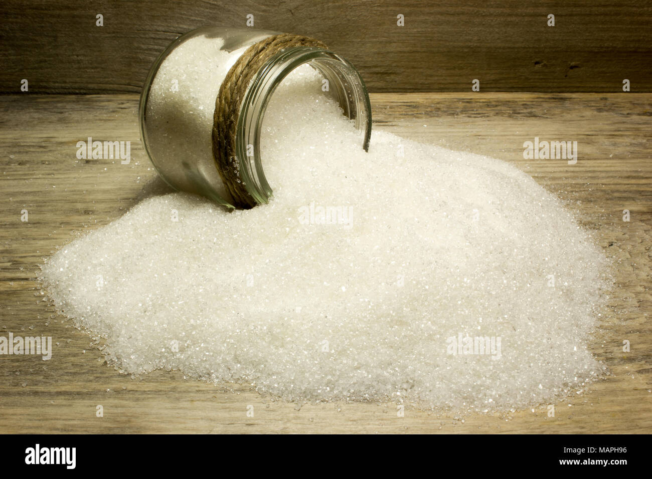 Sugar in glass jar on wooden background Stock Photo