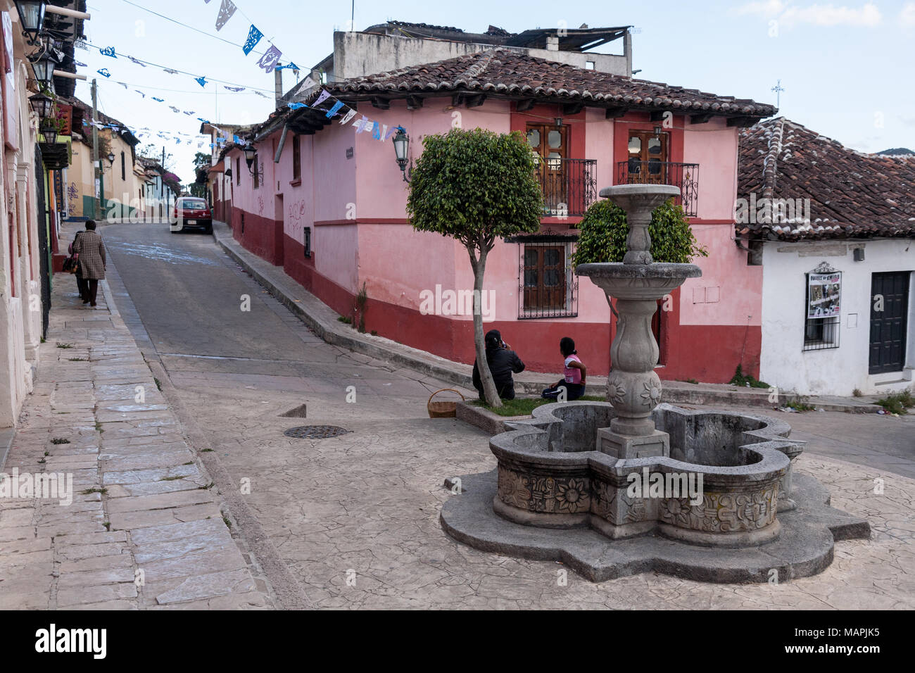 SAN CRISTOBAL, MEXICO - March 8, 2012:  Local mexicans rest at the foutain on a street in San Cristobal De las Casas, Mexico. Stock Photo