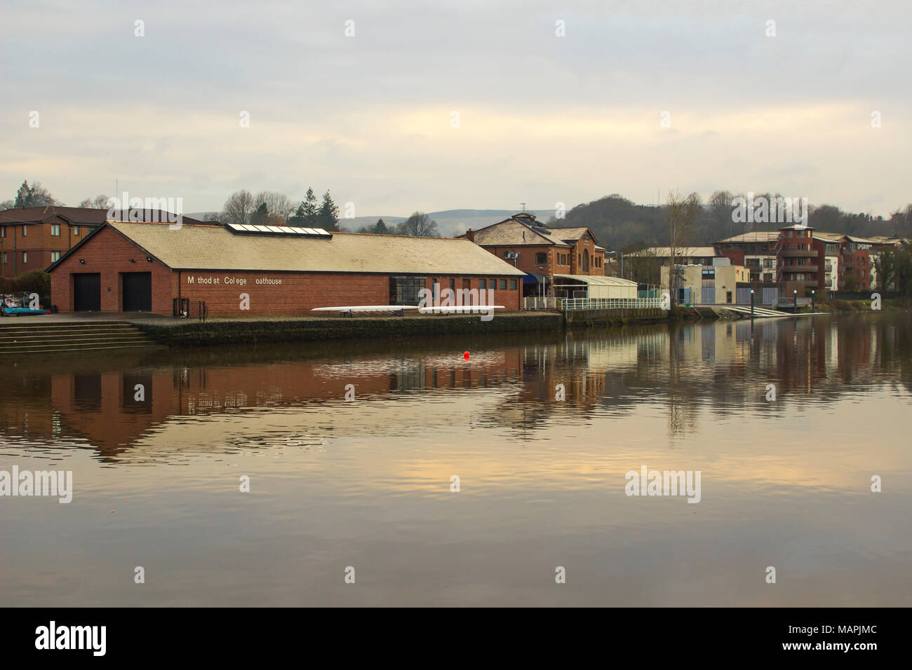 Methodist College boathouse on the calm waters of the River Lagan Northern Ireland on a cool spring evening Stock Photo