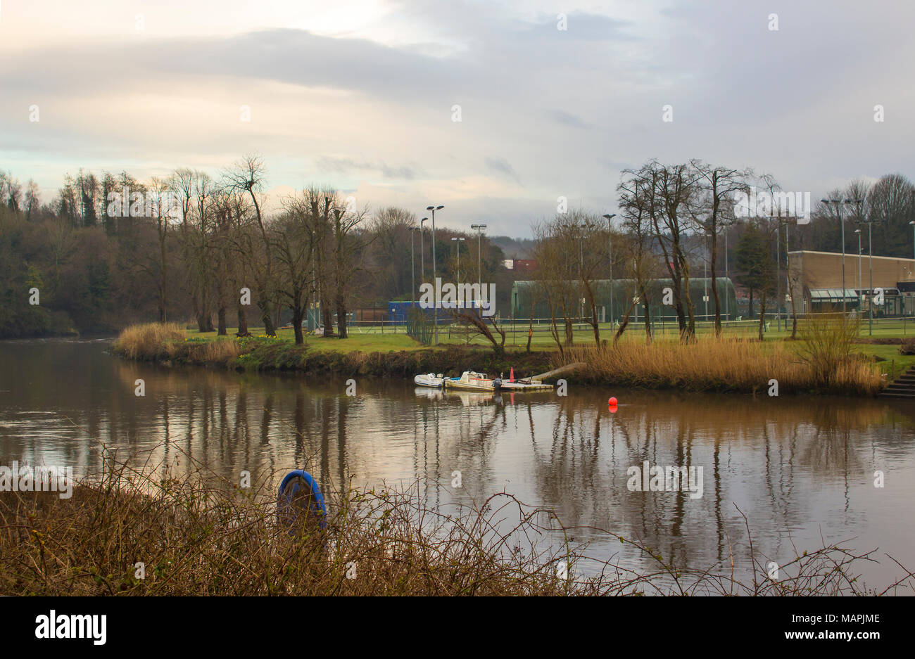 Boats moored on the calm waters of the River Lagan Northern Ireland on a cool spring evening Stock Photo