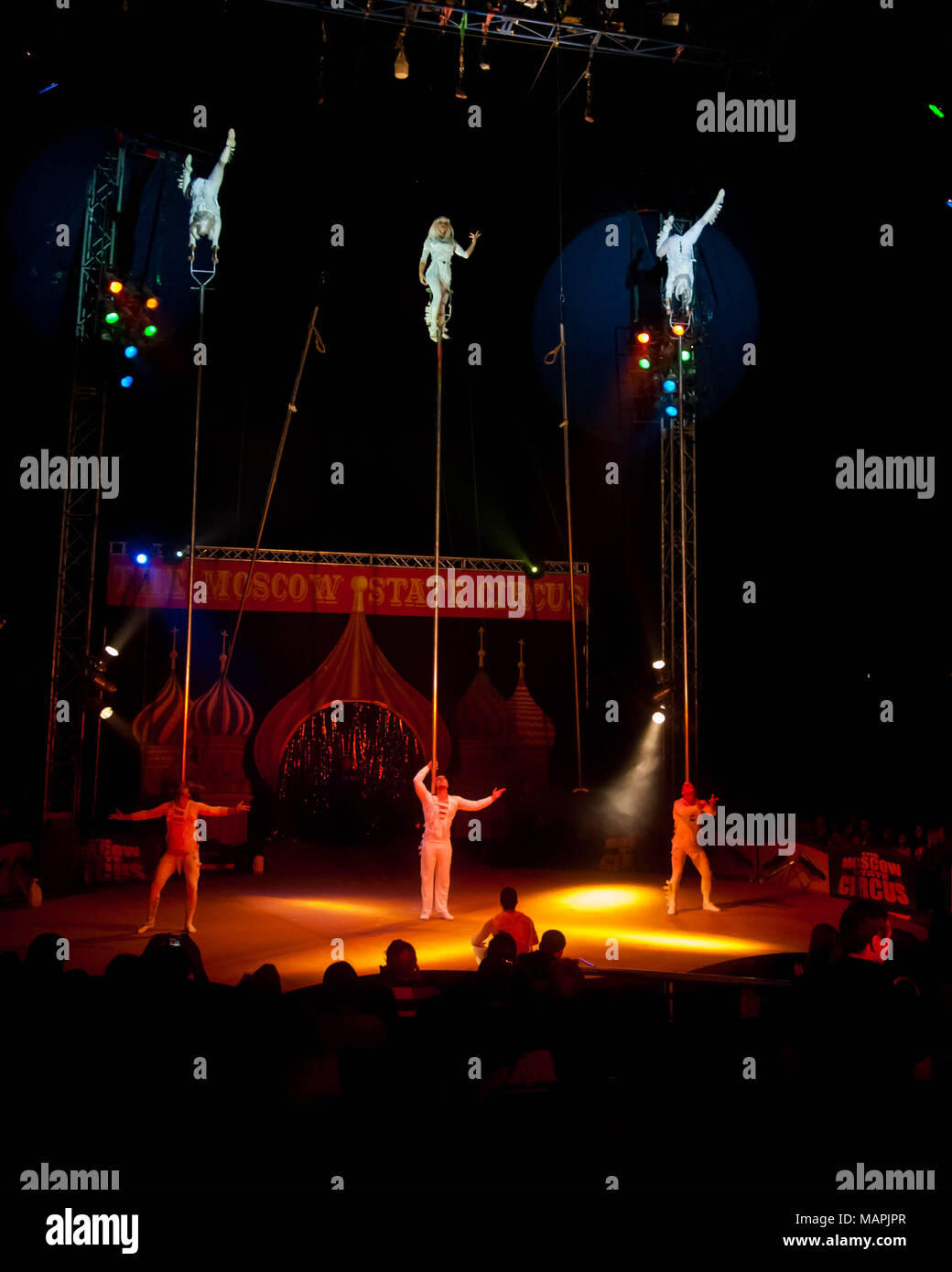Acrobats perform in the ring inside a circus big top Stock Photo