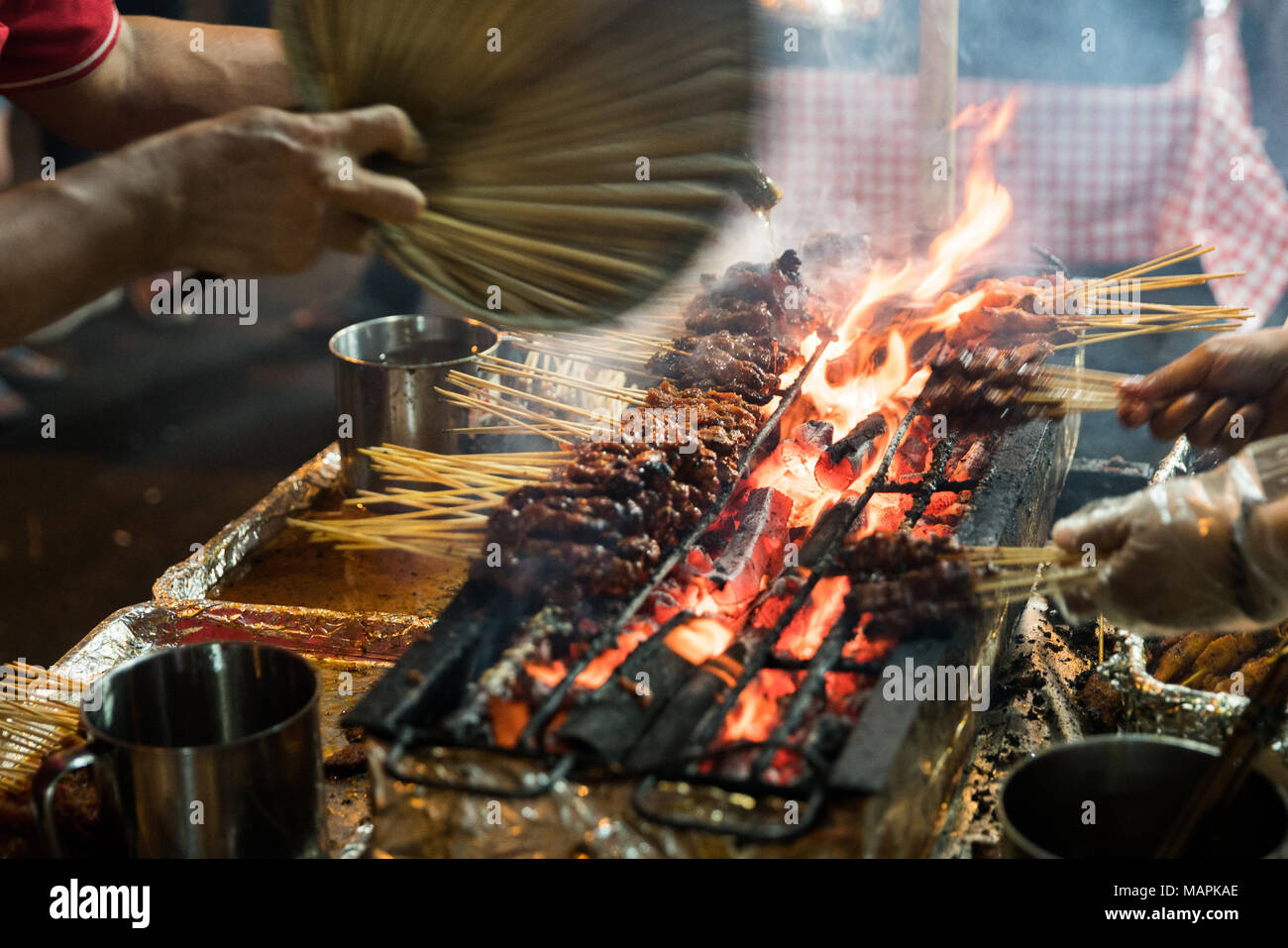 Close Up Meat Skewers Cook Over Hot Coals In Singapore S Satay Street Food Market Stock Photo Alamy