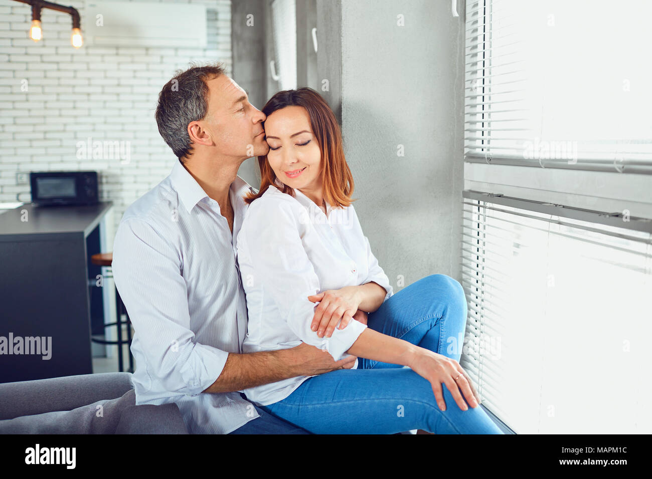 Mature couple happy hugging indoors. Stock Photo