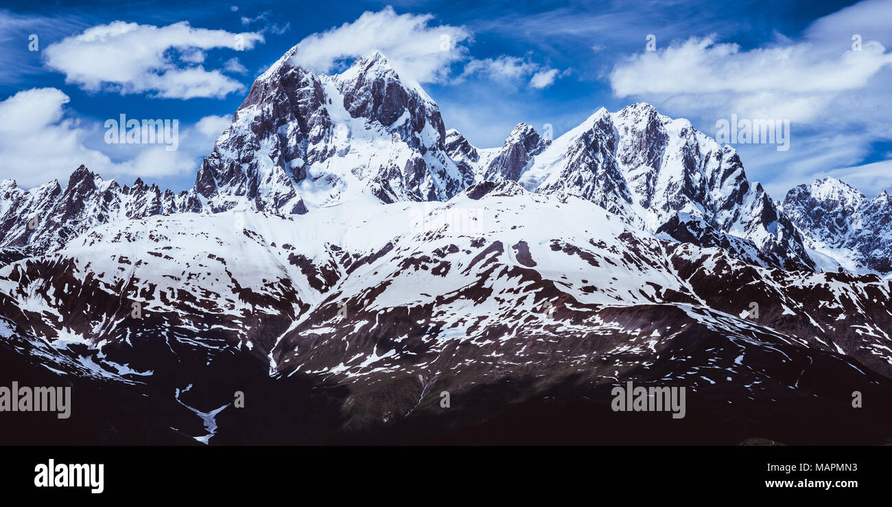 Panoramic view of the Caucasus mountains covered with snow including a famous horned peak Ushba (4690 m). Svaneti region, Georgia Stock Photo