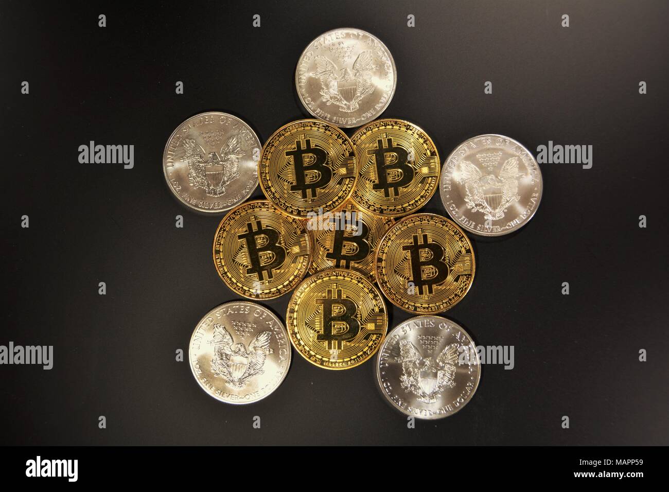 Bit coins with silver dollars and diamonds. Stock Photo