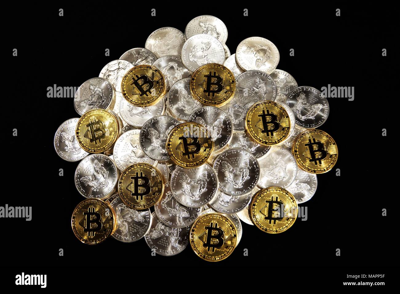Bit coins with silver dollars and diamonds. Stock Photo