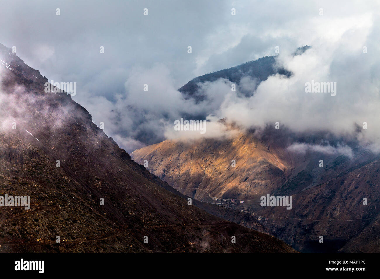 Clouds between peaks in the High Atlas Mountains near Imlil, Morocco Stock Photo