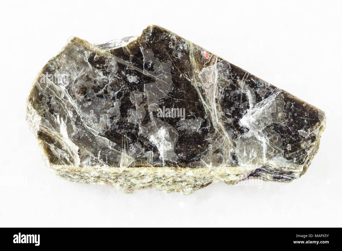 macro shooting of natural mineral rock specimen rough muscovite mica stone on white marble