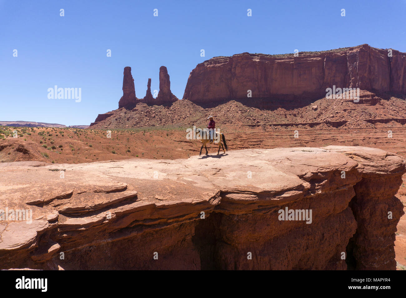 John Ford's Point and the Three Sisters and cowboy on horse, Monument Valley, border of Arizona and Utah, United States of America, North America Stock Photo