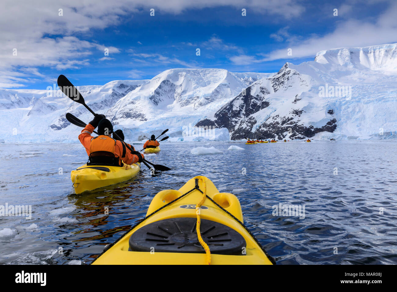 Kayaking amongst spectacular icebergs, mountains and glaciers, sunny