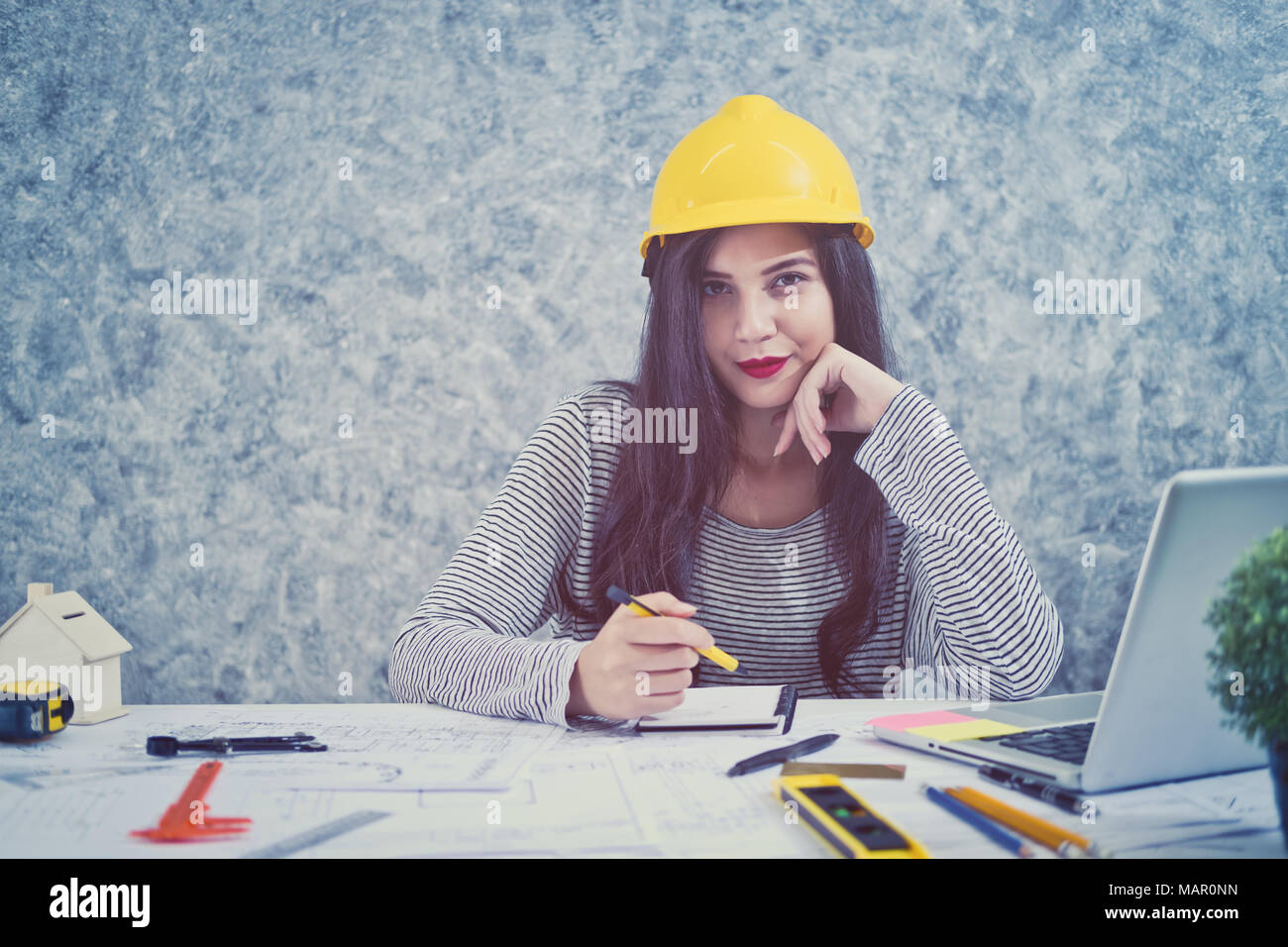 Architect or planner working on drawings for construction plans at a table Stock Photo
