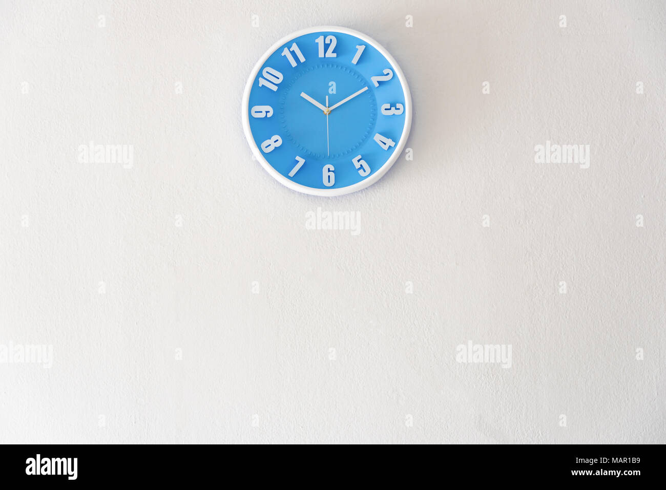 Morning, night or bed time with 10:10 clock on white concrete wall interior background with copy space, message board concept. 10 am is the late time  Stock Photo